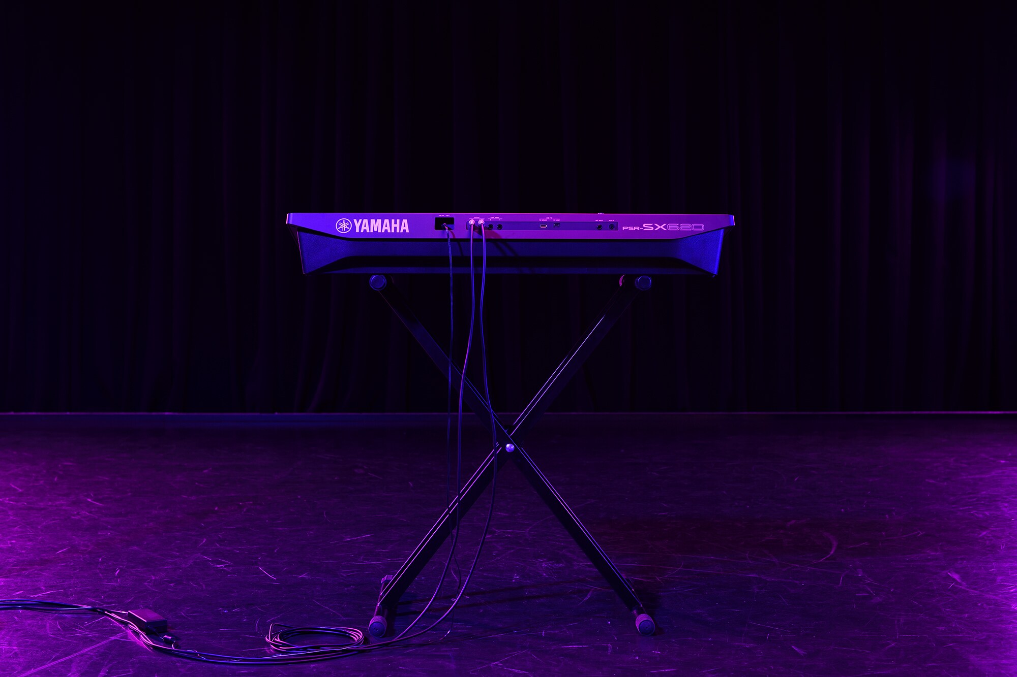 Keyboard na stojanu v záři pódiových reflektorů