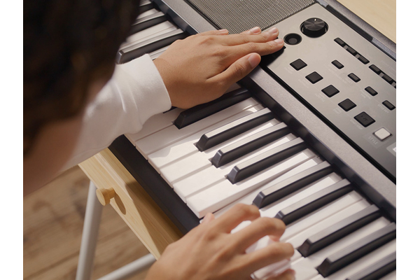 Girl tries different ways of playing with the YPT-380.